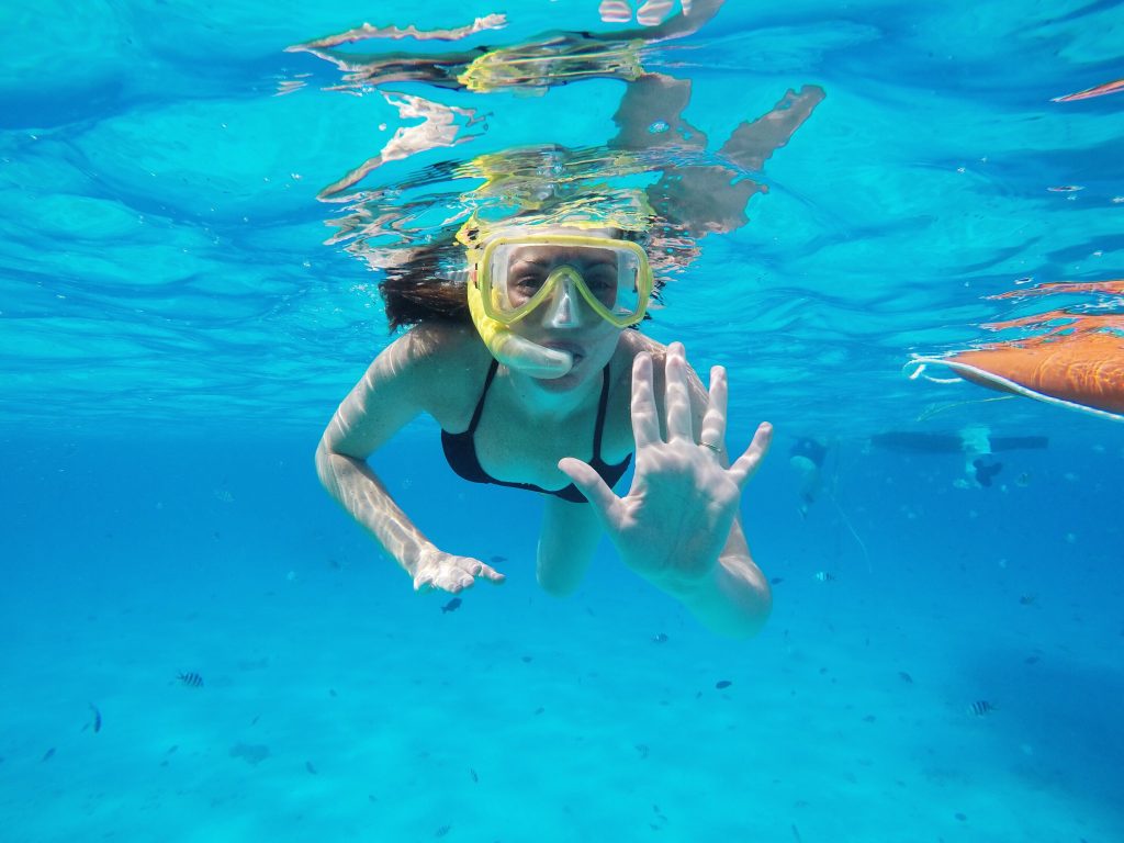 woman snorkeling in crystal clear water on the tropical island of Mauritius